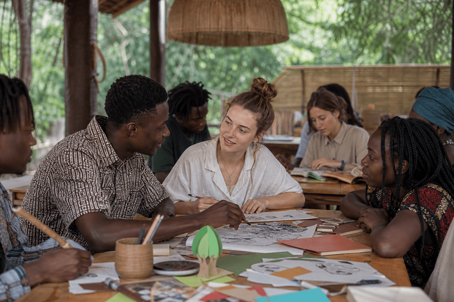 Concept image of Gambian and Russian adults sharing a creative workshop